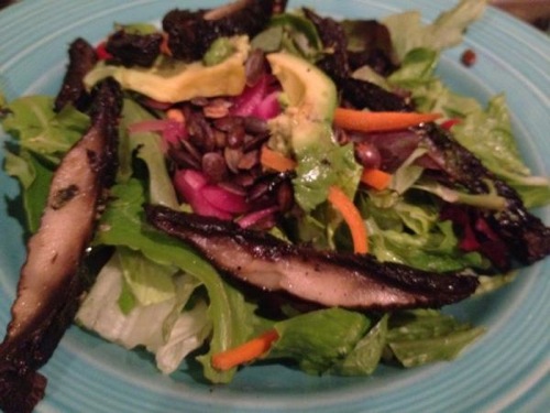 picture of a salad with pickled onions and sliced portobello mushrooms