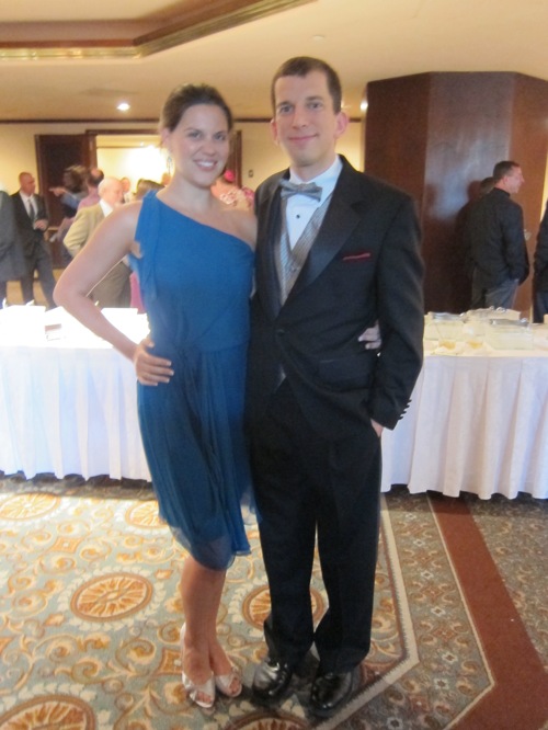 Lindsay in a blue dress and Jim in a suit with a silver vest that matches her shoes